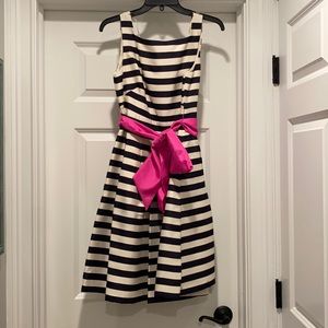 Black and cream striped dress with pink sash/bow.